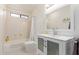 Bright bathroom featuring a vanity with frosted glass, shower with curtain and modern fixtures at 6017 E Kathleen Rd, Scottsdale, AZ 85254