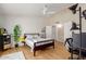 Well-lit bedroom featuring a ceiling fan, hardwood floors, and closet at 6017 E Kathleen Rd, Scottsdale, AZ 85254