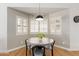 Bright breakfast nook features wood floors, Gathering decor, and three windows with white shutters at 6017 E Kathleen Rd, Scottsdale, AZ 85254