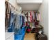 Organized walk-in closet featuring multiple rows of hanging clothes and neatly stacked storage containers at 6017 E Kathleen Rd, Scottsdale, AZ 85254