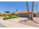 Charming home featuring a tile roof, manicured landscaping, and a spacious driveway at 6017 E Kathleen Rd, Scottsdale, AZ 85254