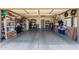View of the open and spacious garage with ample storage shelving and painted floor at 6017 E Kathleen Rd, Scottsdale, AZ 85254