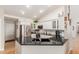 Modern kitchen with stainless steel appliances, black granite countertops, and white cabinets at 6017 E Kathleen Rd, Scottsdale, AZ 85254