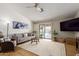Bright living room with hardwood floors, neutral decor, and a view of the outdoor pool at 6017 E Kathleen Rd, Scottsdale, AZ 85254
