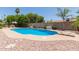 View of the backyard in ground pool with surrounding deck and green foliage at 6017 E Kathleen Rd, Scottsdale, AZ 85254
