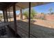 View of a large backyard enclosed by a red brick fence as seen from a covered patio at 6231 N 25Th Ave, Phoenix, AZ 85015