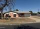 Charming single-story home featuring a pink exterior, attached garage, and well-manicured front yard at 6231 N 25Th Ave, Phoenix, AZ 85015