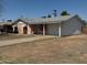 Single story home featuring a pink exterior, attached garage, and a driveway at 6231 N 25Th Ave, Phoenix, AZ 85015