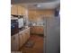 Retro kitchen featuring wooden cabinets, laminate countertops, and vintage appliances at 6231 N 25Th Ave, Phoenix, AZ 85015