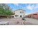 This backyard features a patio, grass, trees and a wall along the perimeter at 6537 W Pioneer St, Phoenix, AZ 85043