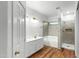 Bright bathroom features a double sink vanity, a soaking tub, and a glass-enclosed shower at 6537 W Pioneer St, Phoenix, AZ 85043