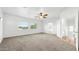 Spacious bedroom with a ceiling fan, carpet floors, and natural light from the window at 6537 W Pioneer St, Phoenix, AZ 85043
