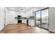 Modern kitchen with stainless steel appliances, white cabinets, and sliding glass doors to the backyard at 6537 W Pioneer St, Phoenix, AZ 85043