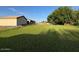 Expansive backyard with lush green grass, mature trees, and plenty of space for outdoor activities at 661 W Via De Palmas --, San Tan Valley, AZ 85140