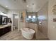 Bathroom highlighting a soaking tub, glass shower, double vanity, and sleek fixtures at 661 W Via De Palmas --, San Tan Valley, AZ 85140