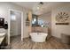 Bathroom showcasing a standalone tub, glass shower, and decorative windmill art on the wall at 661 W Via De Palmas --, San Tan Valley, AZ 85140