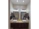 Bathroom vanity features double sinks, granite countertops, dark cabinets, and decorative mirrors at 661 W Via De Palmas --, San Tan Valley, AZ 85140