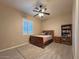 Bedroom with a ceiling fan, window with plantation shutters, and wood-look flooring at 661 W Via De Palmas --, San Tan Valley, AZ 85140