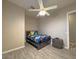 Clean bedroom with modern bed, ceiling fan, and wood look flooring at 661 W Via De Palmas --, San Tan Valley, AZ 85140