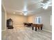 Spacious game room featuring a pool table, foosball, and exercise machine for recreation and fitness at 661 W Via De Palmas --, San Tan Valley, AZ 85140