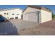 Exterior view of detached garage featuring a large garage door and ample parking space at 661 W Via De Palmas --, San Tan Valley, AZ 85140