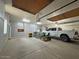 Spacious garage interior with custom storage cabinets, tall ceiling, and room for multiple vehicles at 661 W Via De Palmas --, San Tan Valley, AZ 85140