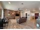 Living room features wood floors, comfortable seating, lots of natural light, and a wood accent wall at 661 W Via De Palmas --, San Tan Valley, AZ 85140