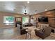 Living room features wood floors, comfortable seating, lots of natural light, and a wood accent wall at 661 W Via De Palmas --, San Tan Valley, AZ 85140