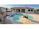 Backyard oasis featuring a large pool, spa, and covered patio, perfect for outdoor entertaining at 661 W Via De Palmas --, San Tan Valley, AZ 85140