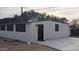Exterior of home featuring three window and a black door at 753 W 6Th Dr, Mesa, AZ 85210