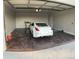 A freshly painted garage holds a white car on an epoxy floor at 753 W 6Th Dr, Mesa, AZ 85210