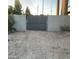 A gray metal gate offers a secure entrance, enclosed by concrete walls at 753 W 6Th Dr, Mesa, AZ 85210