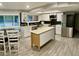 This beautifully remodeled kitchen has stainless steel appliances, an island and a dining area at 753 W 6Th Dr, Mesa, AZ 85210