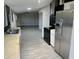 Spacious kitchen with stainless steel appliances seamlessly flows into the living area at 753 W 6Th Dr, Mesa, AZ 85210