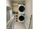 This laundry room has a stacked washer and dryer and built-in cabinets at 753 W 6Th Dr, Mesa, AZ 85210