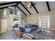 Bright living room featuring high ceilings with beams, modern decor, and glass staircase at 753 W 6Th Dr, Mesa, AZ 85210