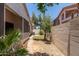 A brick path and desert landscape is seen in the backyard at 7621 S Bonarden Ln, Tempe, AZ 85284