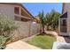 An outdoor area with synthetic grass, brick patio, and block wall at 7621 S Bonarden Ln, Tempe, AZ 85284