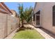 View of backyard with artificial turf and brick pathway at 7621 S Bonarden Ln, Tempe, AZ 85284