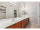 Bathroom featuring a large mirror, dual sinks, and wood cabinetry at 7621 S Bonarden Ln, Tempe, AZ 85284