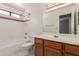 Bathroom featuring a tub and shower combination and wood cabinets at 7621 S Bonarden Ln, Tempe, AZ 85284