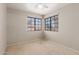 This cozy bedroom has two windows offering great light and a ceiling fan at 7621 S Bonarden Ln, Tempe, AZ 85284