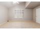 Well-lit room with neutral carpet, shuttered window, and a ceiling fan at 7621 S Bonarden Ln, Tempe, AZ 85284