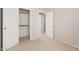 A carpeted bedroom is seen with an open closet and doorways at 7621 S Bonarden Ln, Tempe, AZ 85284
