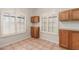 Cozy breakfast nook with white shutters, tile flooring, and wooden cabinetry at 7621 S Bonarden Ln, Tempe, AZ 85284