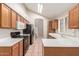 Bright kitchen with white countertops, tile backsplash, stainless steel appliances, and wooden cabinets at 7621 S Bonarden Ln, Tempe, AZ 85284