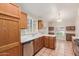 Bright eat-in kitchen featuring tile flooring, wood cabinets, and stainless steel dishwasher at 7621 S Bonarden Ln, Tempe, AZ 85284