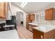 Modern kitchen featuring stainless steel appliances, wood cabinets, tile flooring, and lots of natural light at 7621 S Bonarden Ln, Tempe, AZ 85284