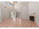 Spacious living room with high ceilings, tile flooring, a fireplace, and lots of natural light at 7621 S Bonarden Ln, Tempe, AZ 85284