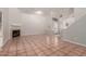 Open-concept living room featuring tile floors, fireplace, and staircase at 7621 S Bonarden Ln, Tempe, AZ 85284